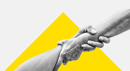 Hands hold each other over yellow triangle